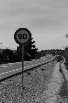 Lonely road with speed road sign in Spain