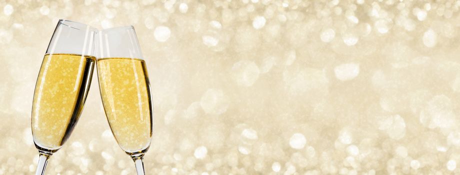 Two glasses of champagne with bokeh lights in the background New Year party celebration concept