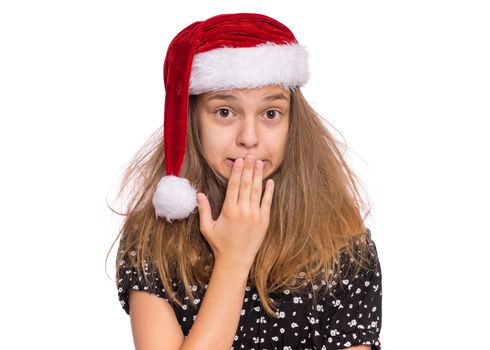 Happy teen girl in Santa red hat, isolated on white background