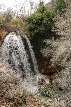Waterfall called El Salto del Caballo and Alcaraz river crossing the natural site of Los Batanes, Alcaraz, Albacete, Spain