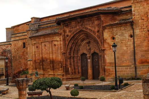 Beautiful Santisima Trinidad Church entrance, gothic style in la plaza Mayor in Alcaraz, Spain