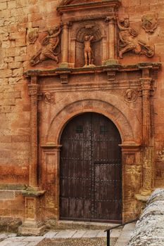 Beautiful Santisima Trinidad Church entrance, gothic style in la plaza Mayor in Alcaraz, Spain
