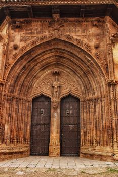 Beautiful Santisima Trinidad Church entrance, gothic style in la plaza Mayor in Alcaraz, Spain