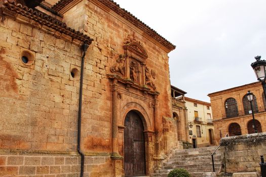 Beautiful Santisima Trinidad Church entrance, gothic style in la plaza Mayor in Alcaraz, Spain