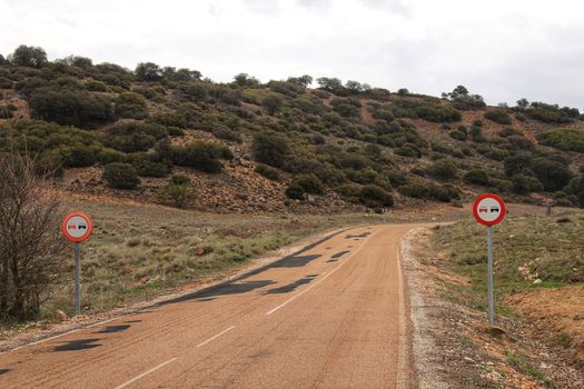 Lonely road with speed road sign in Spain