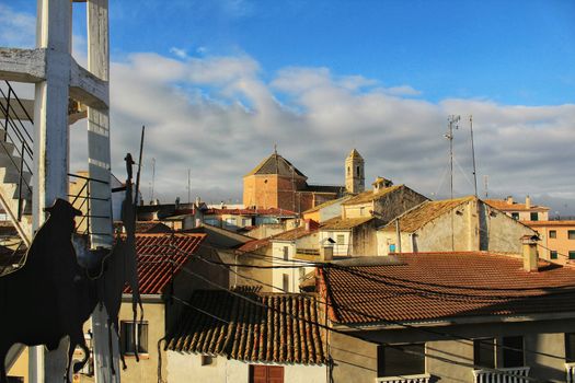 Panoramic of Alborea village at sunrise. Old church in the background and windmill in the foreground.