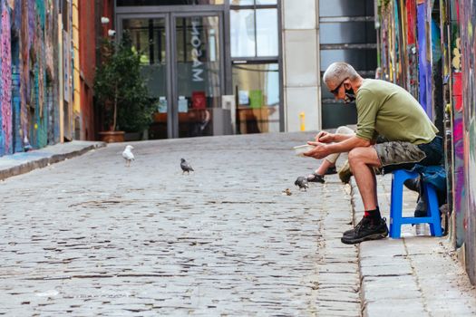 Melbourne, Australia - October 10th 2020: Hosier Lane in Melbourne is quiet and empty with one lone person during the Coronavirus pandemic and associated lockdown.