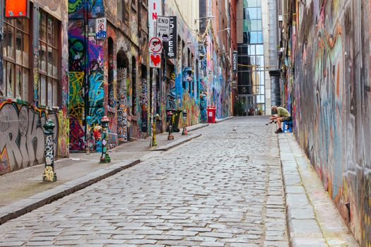 Melbourne, Australia - October 10th 2020: Hosier Lane in Melbourne is quiet and empty with one lone person during the Coronavirus pandemic and associated lockdown.