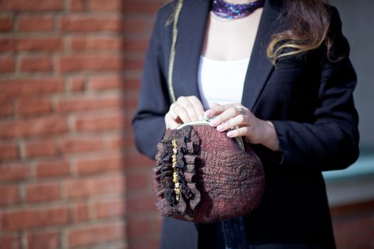 brown Elegant Felting wool fashion handmade handbag in hand. street fashion look