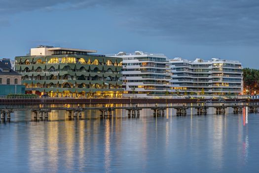 New apartment buildings at the river Spree in Berlin at dusk