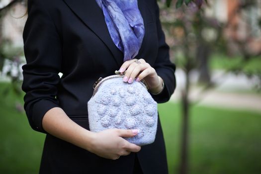 gray Elegant Felting wool fashion handmade handbag in hand. street fashion look