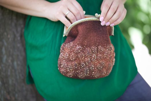 brown Elegant Felting wool fashion handmade handbag in hand. street fashion look