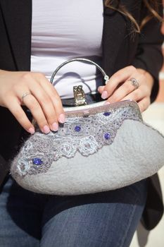gray Elegant Felting wool fashion handmade handbag in hand. street fashion look