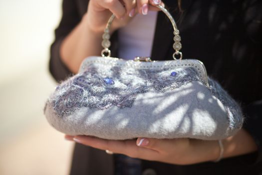 gray Elegant Felting wool fashion handmade handbag in hand. street fashion look