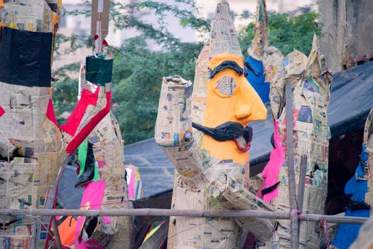 half finished ravan effigies made with a bamboo frame and paper mache and colorful paper covering for the hindu festival of dussera. Shows the statues that are filled with fireworks like guy fawkes and then set ablaze to show the victory of good over evil in the hindu epic of ramayana