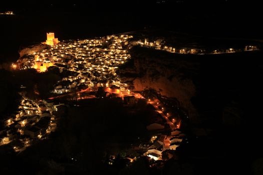 Views of the illuminated village of Alcala del Jucar at night from the viewpoint in Spring