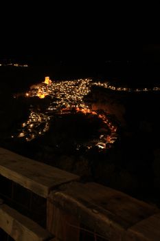 Views of the illuminated village of Alcala del Jucar at night from the viewpoint in Spring