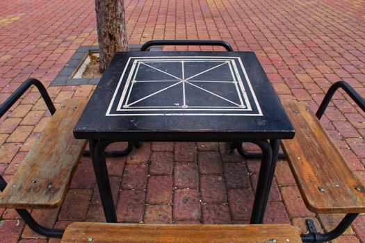 Board games on the street on wooden table and chairs