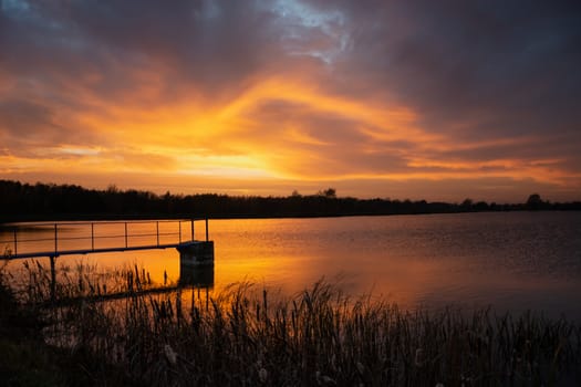 Colorful evening clouds during sunset over the lake, Staw, Poland