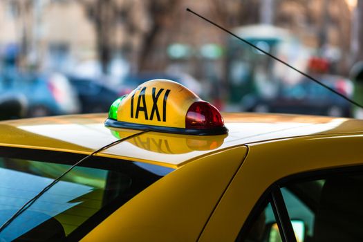 Detail of taxi sign on yellow taxi car in Bucharest, Romania