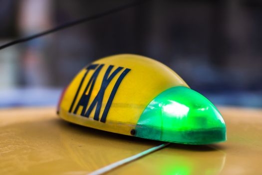 Detail of taxi sign on yellow taxi car in Bucharest, Romania