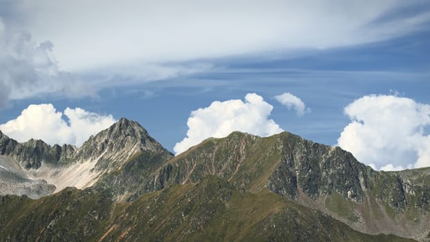 The high mountains of the Austrian Alps in Kuhtai during summer season. The sunshine illuminates the beautiful landscape.