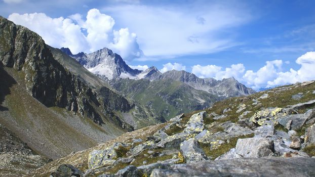 The high mountains of the Austrian Alps in Kuhtai during summer season. The sunshine illuminates the beautiful landscape.