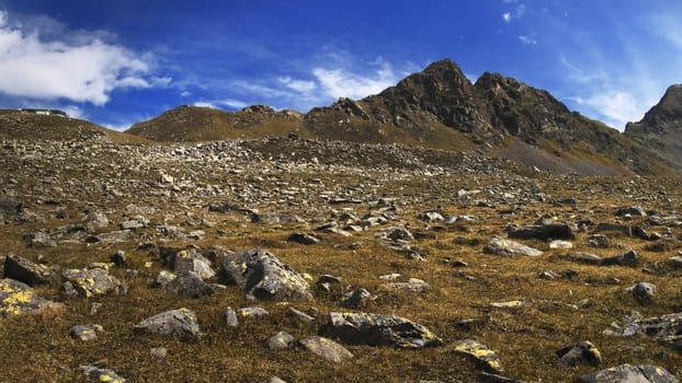 The high mountains of the Austrian Alps in Kuhtai during summer season. The sunshine illuminates the beautiful landscape.