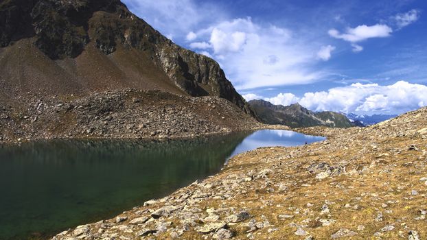 The high mountains of the Austrian Alps in Kuhtai during summer season. The sunshine illuminates the beautiful landscape.