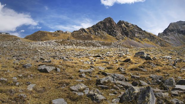 The high mountains of the Austrian Alps in Kuhtai during summer season. The sunshine illuminates the beautiful landscape.