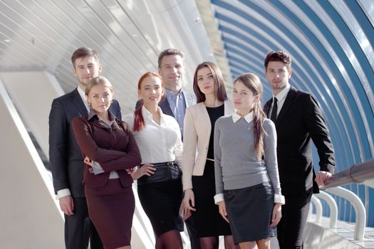 Portrait of business team of men and women in modern building