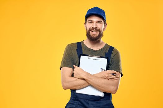 Man in working form documents transportation delivery service yellow background. High quality photo