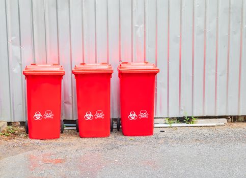 red bins three with symbol infectious in the outdoors keep clean from germs virus. concept prevent garbage infection coronavirus (covid-19)