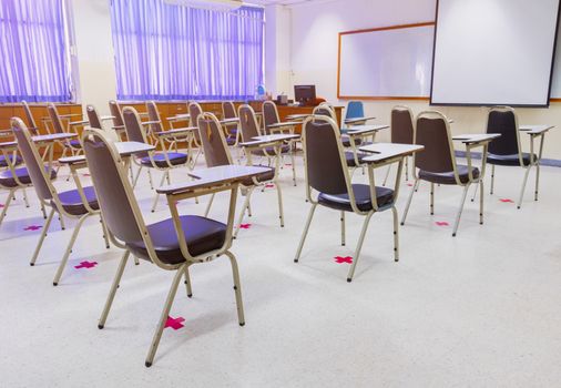 old lecture chairs empty in classroom with social distancing in prevent COVID-19. back to school