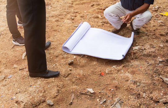 architect plans surveying prepare work construction new building on land empty