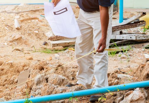 architect plans surveying prepare work construction new building on land empty