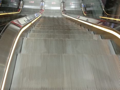 Escalator closeup in shopping mall for up down