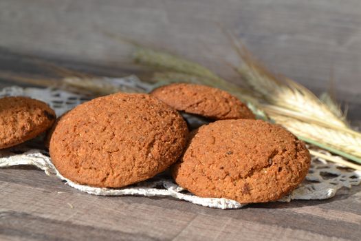 oat cookies and spikelets on sackcloth closeup