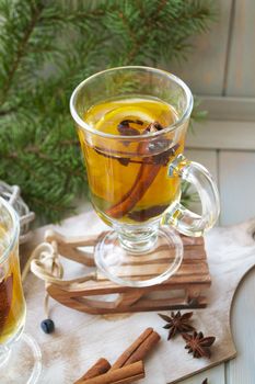 Mulled cider with added spices. A delicious and warming hot drink perfect for autumn and winter evenings. Vertical image