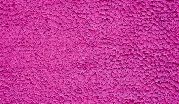 Rough decorative relief . Maroon decorative plastered wall. Maroon wall background.