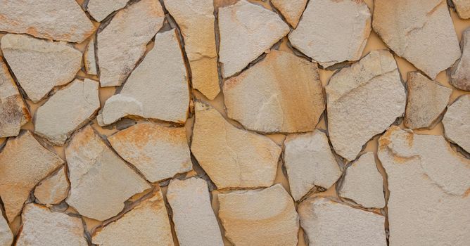 Natural stone walls. Beige textured wall background for interior design.
