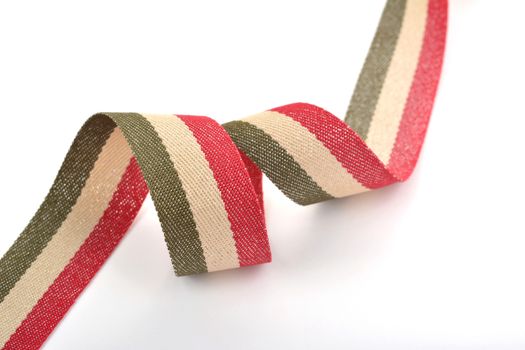 Red khaki green beige Cotton ribbon, strapping tape with curl on white backgroud. Use for sewing clothes, bags. Space for text.