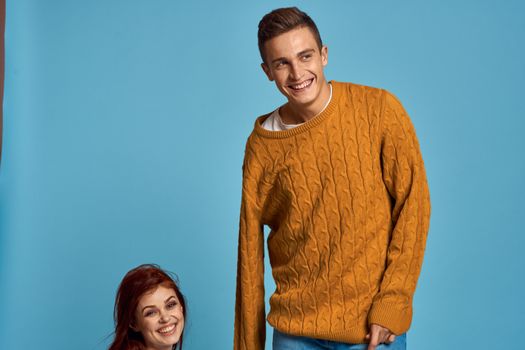 Man in sweater on blue background and woman cropped view of emotion. High quality photo