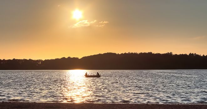 Beautiful sunset landscape at a lake with a reflective water surface.