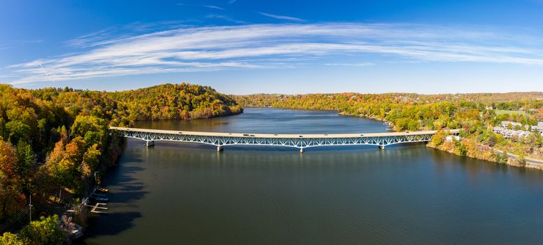 Aerial drone panorama of the autumn fall colors surrounding Cheat Lake and the interstate I68 bridge near Morgantown, West Virginia
