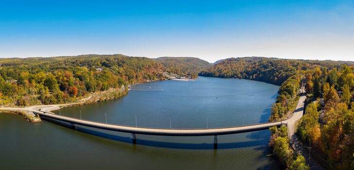Aerial drone panorama of the autumn fall colors surrounding Cheat Lake and the Old Cheat Road bridge near Morgantown, West Virginia