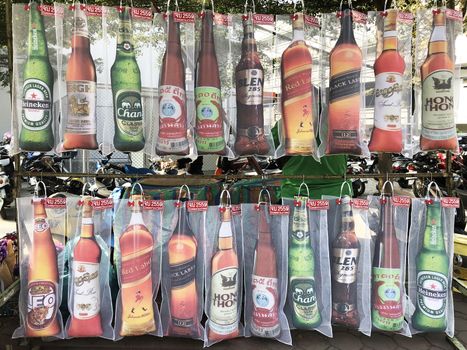 13 DEC : A street souvenir stand selling pillows imitating bottles of different beer brands on the Graduation Day at Khon Kaen University in 13 December 2017 Khon Kaen, Thailand.
