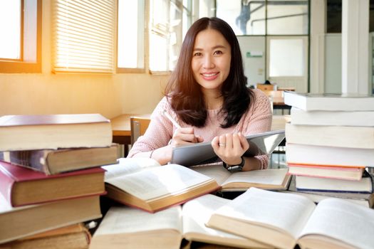 Young woman using tablet in a library