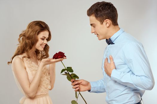 Man and woman with red rose romance love family couple holiday. High quality photo