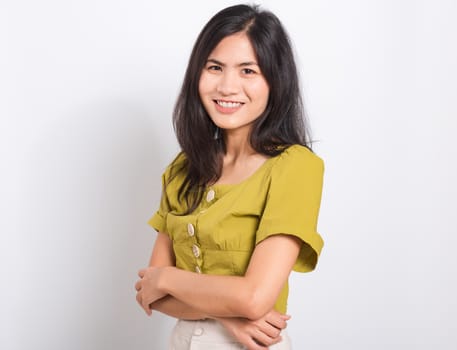 Portrait Asian beautiful young woman standing smile seeing white teeth, She crossed her arms and looking at camera, shoot photo in studio on white background